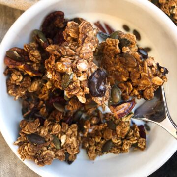 The crunchy granola in clusters served with milk.