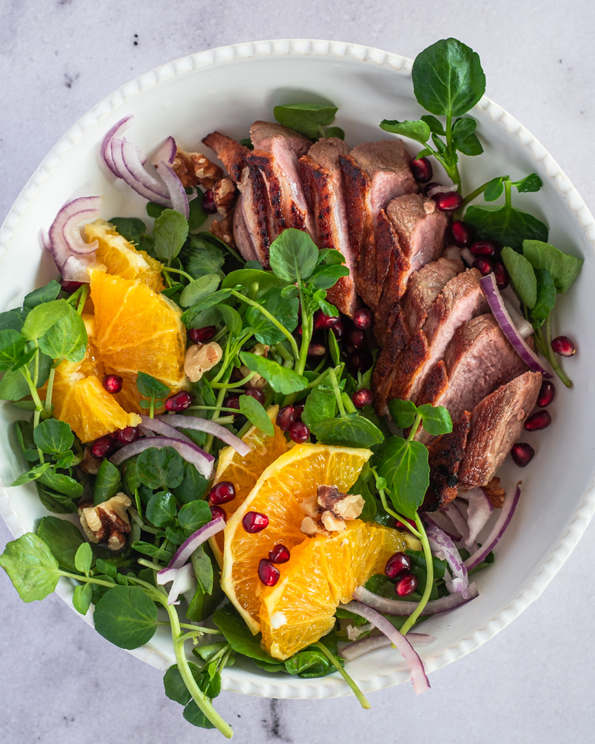 Crispy duck with orange and pomegranate seeds