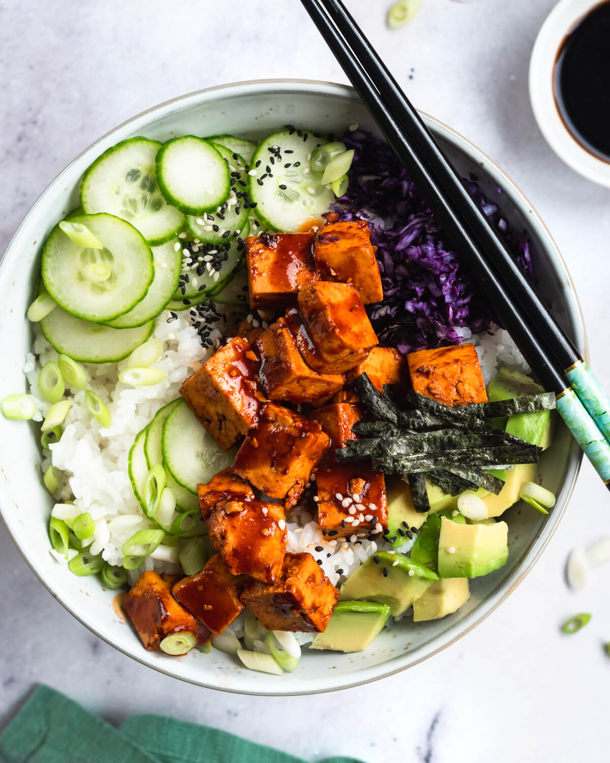 A poke bowl with sticky sweet and spicy tofu and vegetables
